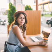 Female digital nomad with coffee at France cafe